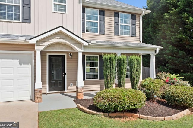 174 Randall Dr, Rockmart, GA 30153 - view of exterior entry featuring a garage and board and batten siding