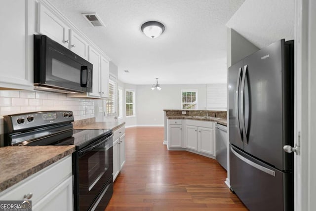 174 Randall Dr, Rockmart, GA 30153 - kitchen featuring black appliances, a peninsula, dark wood finished floors, decorative backsplash, and white cabinets