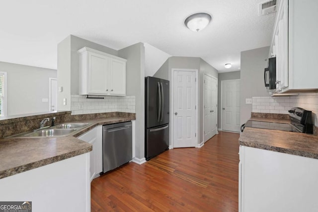 174 Randall Dr, Rockmart, GA 30153 - kitchen featuring black appliances, dark countertops, a sink, and dark wood finished floors
