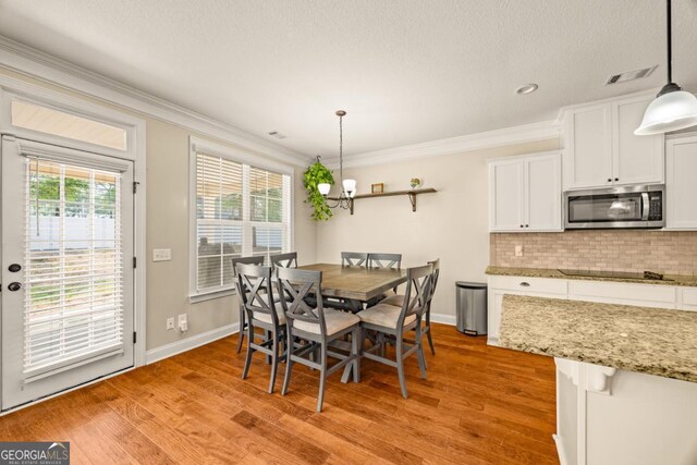86 Crestview Dr, Guyton, GA 31312 - dining area featuring ornamental molding, light wood-style flooring, baseboards, and a chandelier