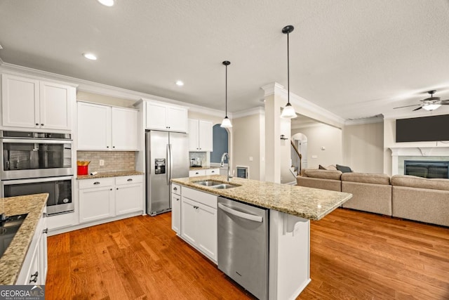 86 Crestview Dr, Guyton, GA 31312 - kitchen featuring stainless steel appliances, a sink, ornamental molding, ceiling fan, and wood finished floors