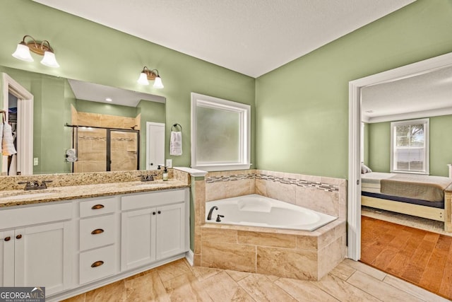 86 Crestview Dr, Guyton, GA 31312 - bathroom with connected bathroom, a shower stall, a bath, and double vanity