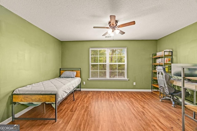 86 Crestview Dr, Guyton, GA 31312 - bedroom with wood finished floors, a textured ceiling, baseboards, and an office area