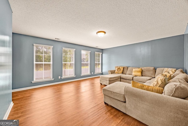 86 Crestview Dr, Guyton, GA 31312 - living area featuring wood finished floors, baseboards, and a textured ceiling
