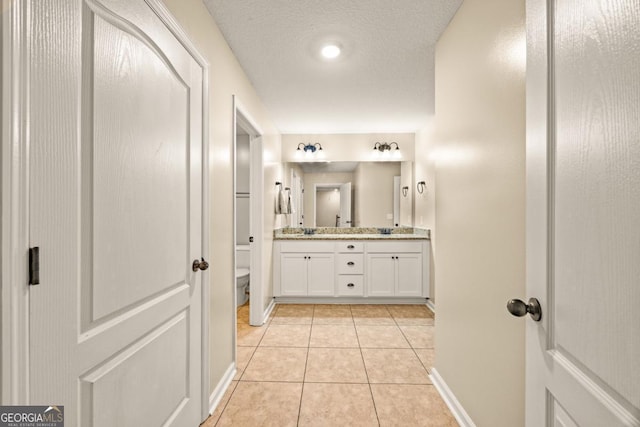 86 Crestview Dr, Guyton, GA 31312 - bathroom with double vanity, baseboards, toilet, and tile patterned floors
