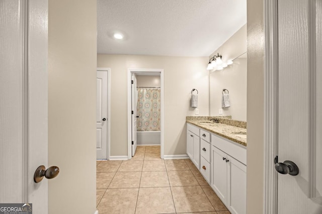 86 Crestview Dr, Guyton, GA 31312 - full bath with double vanity, tile patterned flooring, a textured ceiling, and baseboards