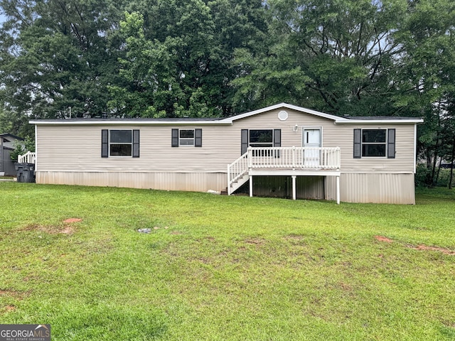 368 Hemlock Ln, Locust Grove, GA 30248 - view of front facade featuring a deck, a front lawn, stairs, and view of scattered trees