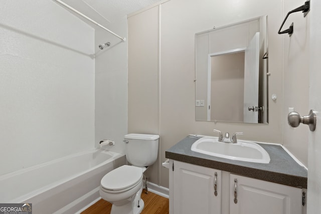 368 Hemlock Ln, Locust Grove, GA 30248 - bathroom featuring toilet, vanity, shower / bathtub combination, wood finished floors, and baseboards