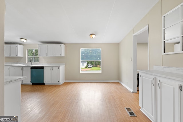 368 Hemlock Ln, Locust Grove, GA 30248 - kitchen with dishwashing machine, light wood-style floors, plenty of natural light, and white cabinets