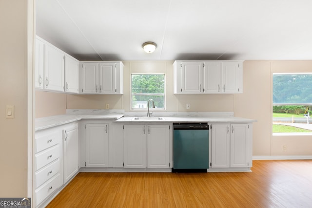 368 Hemlock Ln, Locust Grove, GA 30248 - kitchen with dishwashing machine, light wood finished floors, light countertops, white cabinets, and a sink