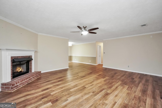 602 Pine Knoll Ct, Mcdonough, GA 30252 - unfurnished living room with a ceiling fan, hardwood / wood-style flooring, a fireplace, baseboards, and ornamental molding