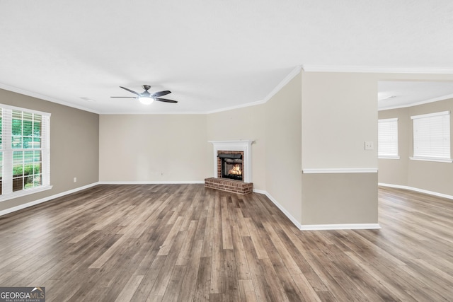 602 Pine Knoll Ct, Mcdonough, GA 30252 - unfurnished living room with wood finished floors, crown molding, a fireplace, a ceiling fan, and baseboards