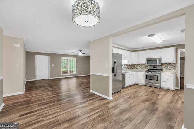 602 Pine Knoll Ct, Mcdonough, GA 30252 - kitchen with appliances with stainless steel finishes, light countertops, wood finished floors, ceiling fan, and open floor plan