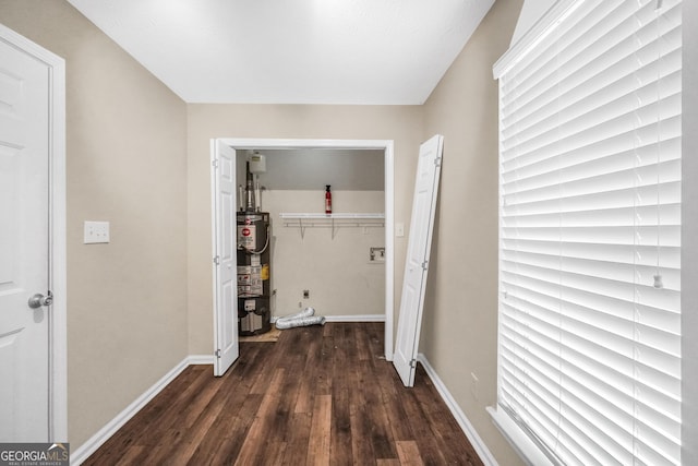 602 Pine Knoll Ct, Mcdonough, GA 30252 - hall with water heater, dark wood finished floors, and baseboards