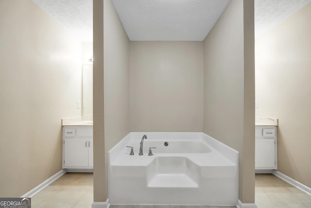 602 Pine Knoll Ct, Mcdonough, GA 30252 - bathroom with vanity, a bath, a textured ceiling, and baseboards