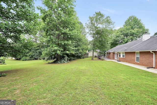 602 Pine Knoll Ct, Mcdonough, GA 30252 - view of green lawn featuring a patio area