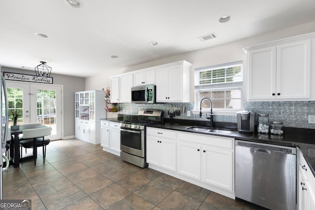 784 Crestworth Xing, Powder Springs, GA 30127 - kitchen with stainless steel appliances, tasteful backsplash, dark countertops, white cabinets, and recessed lighting