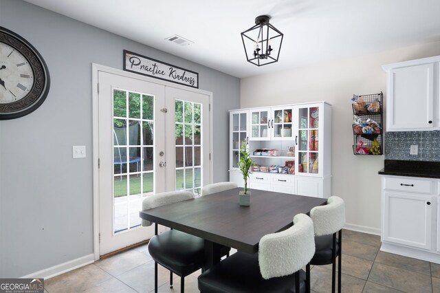 784 Crestworth Xing, Powder Springs, GA 30127 - tiled dining room featuring french doors and a chandelier