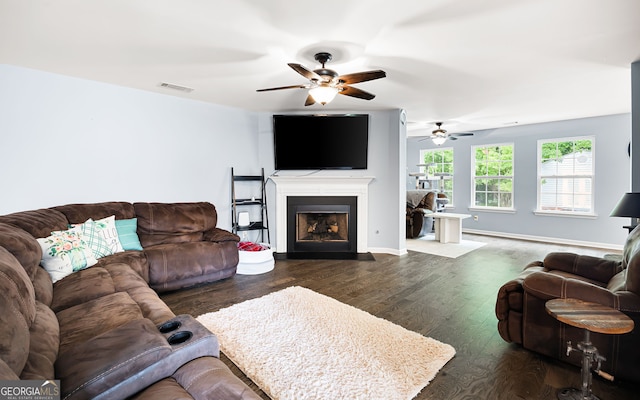784 Crestworth Xing, Powder Springs, GA 30127 - living area with a ceiling fan, dark wood-style flooring, and a fireplace with flush hearth