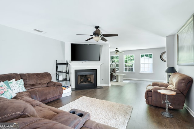 784 Crestworth Xing, Powder Springs, GA 30127 - living area featuring a ceiling fan, dark wood-style flooring, and a fireplace with flush hearth