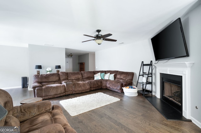 784 Crestworth Xing, Powder Springs, GA 30127 - living room featuring dark wood-style flooring, ceiling fan, and a fireplace with raised hearth
