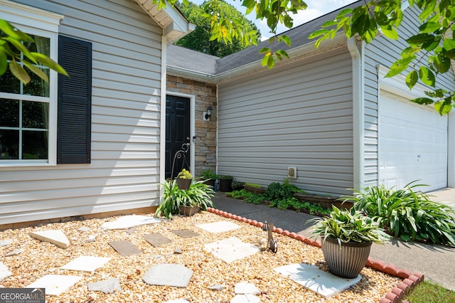 784 Crestworth Xing, Powder Springs, GA 30127 - property entrance featuring a garage, stone siding, and roof with shingles