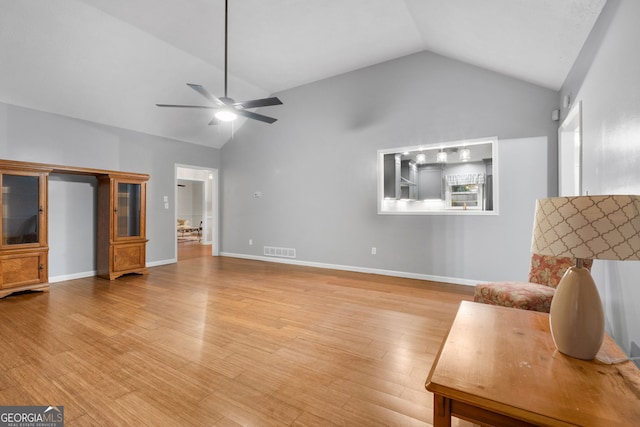7972 Woods Ln, Jonesboro, GA 30236 - living area featuring lofted ceiling, ceiling fan, light wood-type flooring, and baseboards