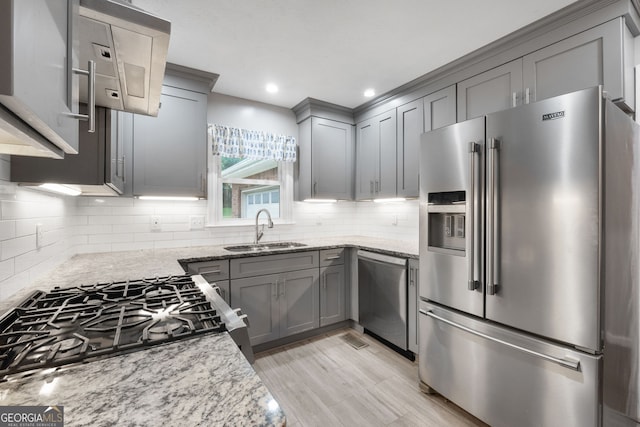 7972 Woods Ln, Jonesboro, GA 30236 - kitchen with appliances with stainless steel finishes, a sink, gray cabinets, light stone countertops, and decorative backsplash