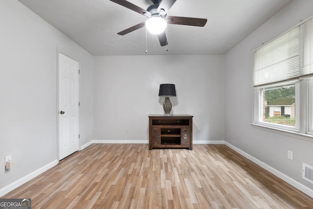 7972 Woods Ln, Jonesboro, GA 30236 - unfurnished living room featuring light wood-type flooring, baseboards, and a ceiling fan