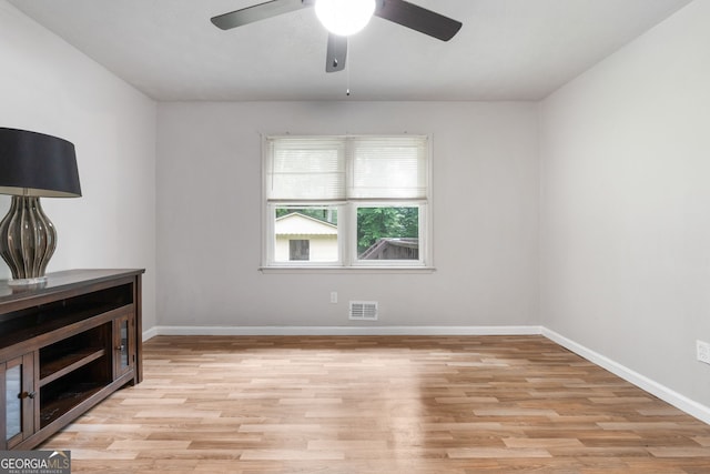 7972 Woods Ln, Jonesboro, GA 30236 - empty room with light wood finished floors, ceiling fan, and baseboards