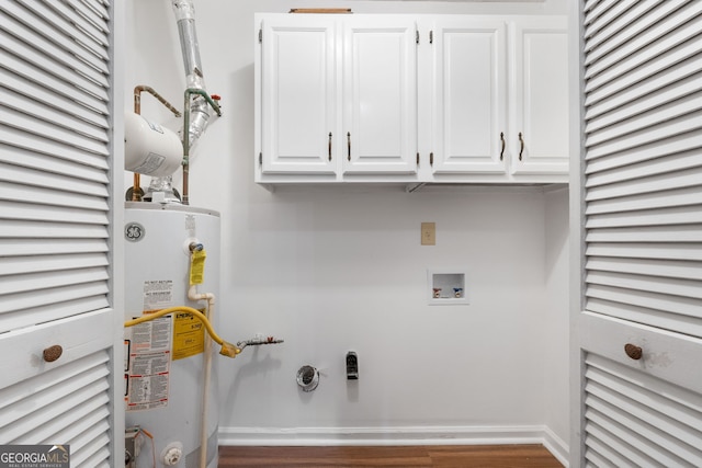 7972 Woods Ln, Jonesboro, GA 30236 - laundry area with gas water heater, cabinet space, wood finished floors, washer hookup, and baseboards
