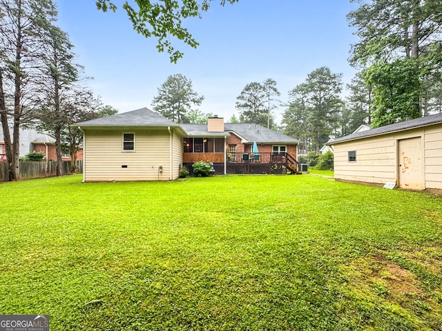7972 Woods Ln, Jonesboro, GA 30236 - back of property with a sunroom, a deck, and a chimney