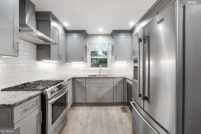 7972 Woods Ln, Jonesboro, GA 30236 - kitchen with stainless steel appliances, wall chimney range hood, gray cabinets, a sink, and light stone countertops