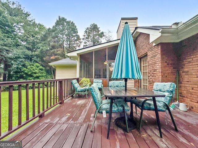 7972 Woods Ln, Jonesboro, GA 30236 - wooden deck featuring a sunroom, outdoor dining area, and a lawn