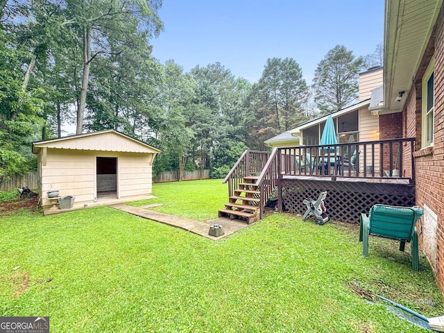 7972 Woods Ln, Jonesboro, GA 30236 - view of yard featuring a deck, an outdoor structure, view of wooded area, and stairway