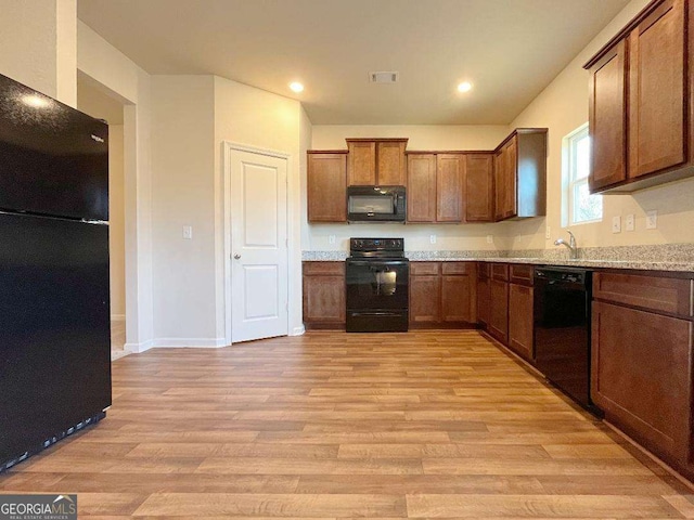 279 Darling Ln, Pendergrass, GA 30567 - kitchen featuring black appliances, light wood-style flooring, recessed lighting, and brown cabinets