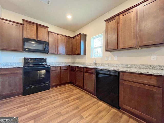 279 Darling Ln, Pendergrass, GA 30567 - kitchen with black appliances, light wood-style floors, recessed lighting, and light stone counters