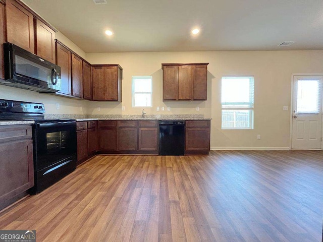 279 Darling Ln, Pendergrass, GA 30567 - kitchen with black appliances, light wood-type flooring, healthy amount of natural light, light countertops, and recessed lighting