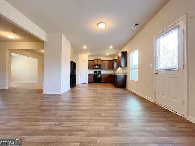 279 Darling Ln, Pendergrass, GA 30567 - kitchen with black appliances, open floor plan, wood finished floors, and light countertops