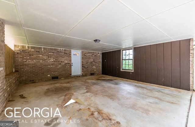 1236 S Shadygrove Ct, Stone Mountain, GA 30083 - additional living space with unfinished concrete flooring and brick wall
