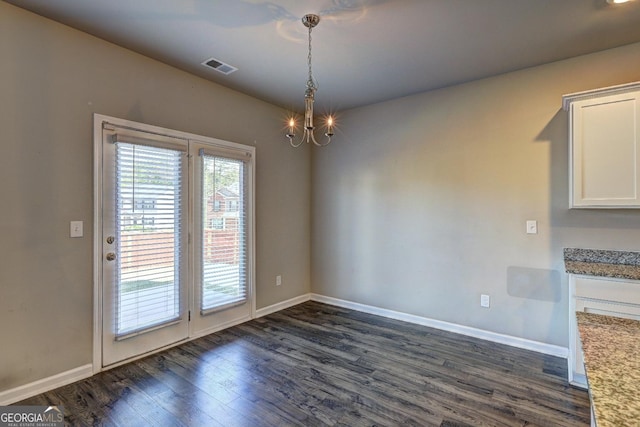 237 Cranapple Ln, Mcdonough, GA 30253 - unfurnished dining area with dark wood-type flooring, baseboards, and a chandelier