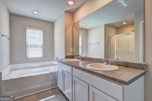 237 Cranapple Ln, Mcdonough, GA 30253 - bathroom featuring a garden tub, double vanity, a shower stall, and recessed lighting