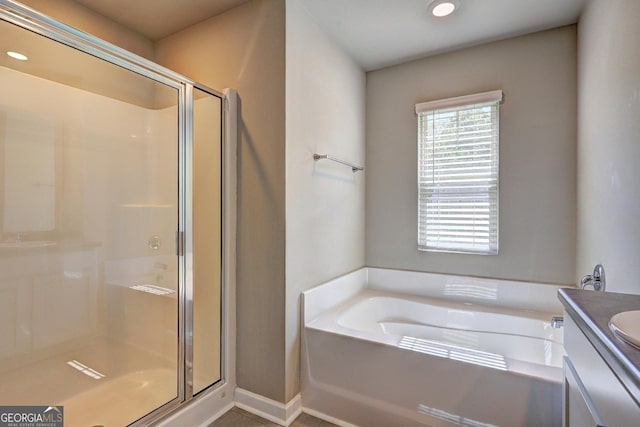 237 Cranapple Ln, Mcdonough, GA 30253 - bathroom with a stall shower, vanity, a garden tub, recessed lighting, and baseboards