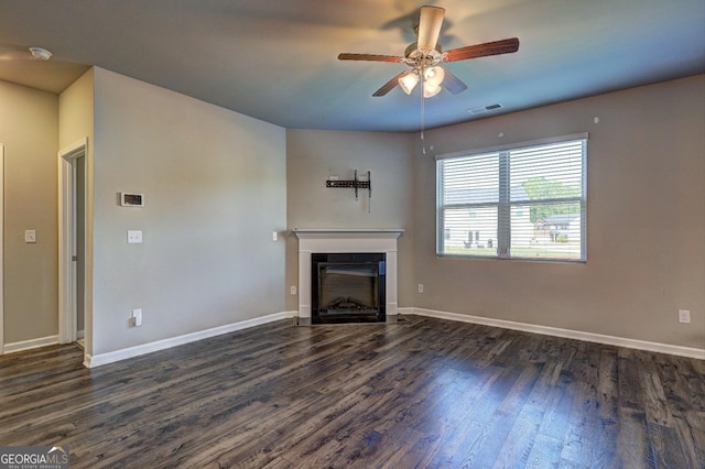 237 Cranapple Ln, Mcdonough, GA 30253 - unfurnished living room featuring dark wood-style floors, a fireplace, ceiling fan, and baseboards