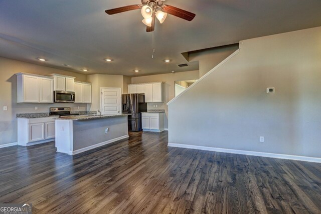 237 Cranapple Ln, Mcdonough, GA 30253 - kitchen with appliances with stainless steel finishes, baseboards, a ceiling fan, white cabinetry, and dark wood finished floors