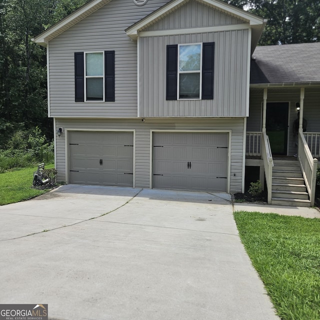 1649 Deer Creek Ln, Monroe, GA 30655 - split level home with an attached garage, board and batten siding, driveway, stairway, and a porch