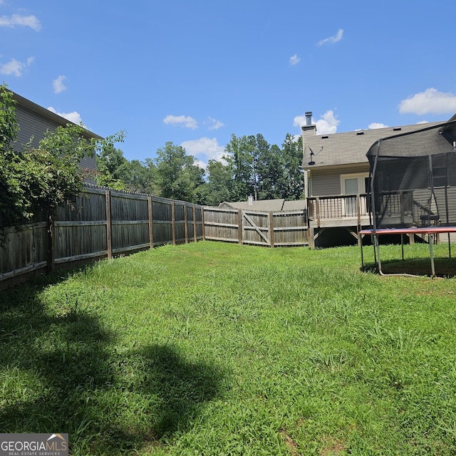 1649 Deer Creek Ln, Monroe, GA 30655 - fenced backyard with a trampoline