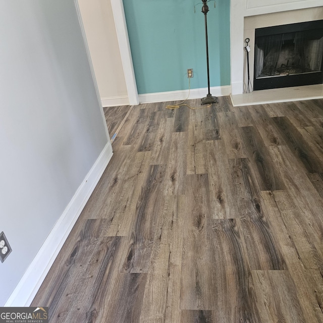 1649 Deer Creek Ln, Monroe, GA 30655 - unfurnished living room featuring wood finished floors and a fireplace with raised hearth