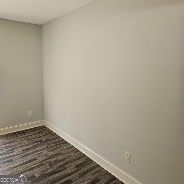 1649 Deer Creek Ln, Monroe, GA 30655 - spare room featuring baseboards and dark wood-type flooring