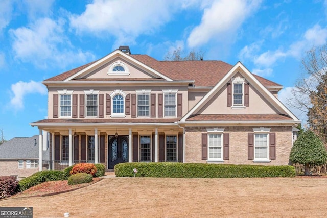 5810 Old Mill Trce, Lithonia, GA 30038 - view of front facade with covered porch, stucco siding, and brick siding